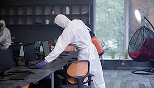 Man cleaning in PPE