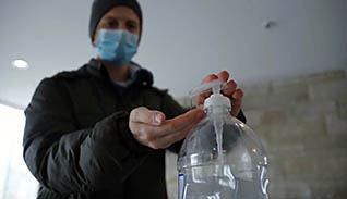 Man putting on hand sanitizer