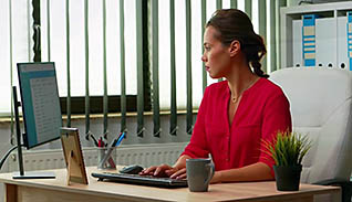 Woman typing on a computer