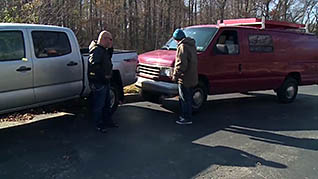 Two men exchanging information after a car accident