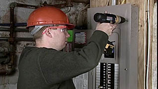 A man working on a electrical box