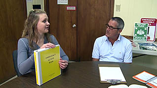 Employees going over the emergency planning book