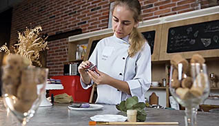 Woman preparing food on a plate