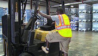 A man getting on a forklift