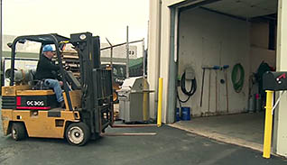 A man putting the forklift away