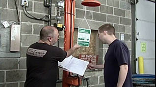 A man showing an employee how to use the shower