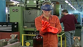 A woman putting protective gloves on