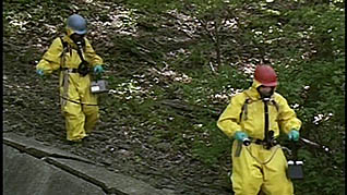 Two people dressed in hazmat suit