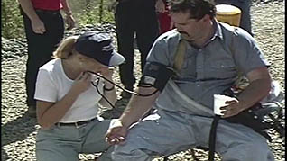 A women checking a mans blood pressure