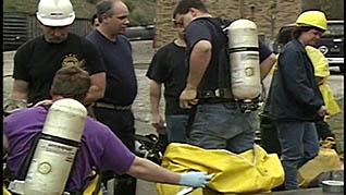 A man taking off a hazmat suit