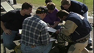 A group of men reading a health plan