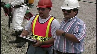 An employee speaking with a safety officer