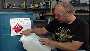 A man reading a hazard label