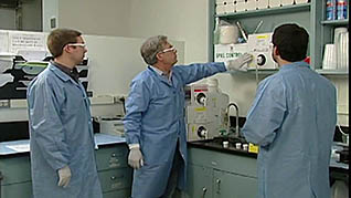 A man showing co-workers where the first aid is