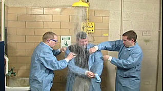 A man washing chemicals off him