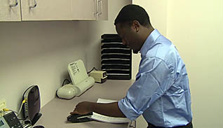 Man cleaning up his work station