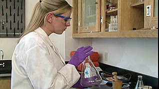 A women cleaning a beaker