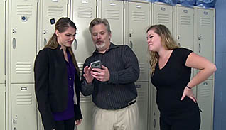 Man showing women something on his phone