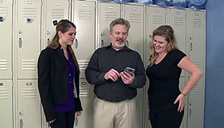 Man showing women something on his phone