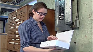 A woman working on an electric box