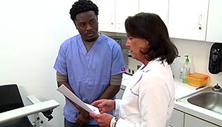 A doctor talking with a nurse