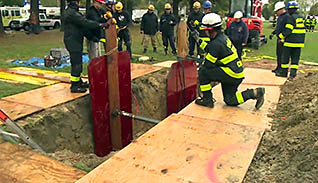 Firefighters digging a trench
