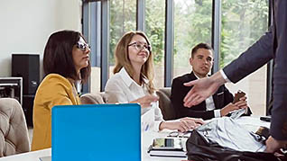 Three employees talking together