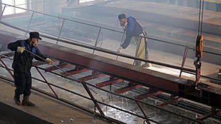 Two men cleaning equipment