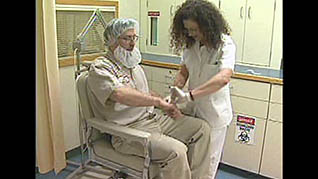 A woman checking a mans pulse at a food manufacturing plant