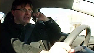 A man talking on his cellphone while driving