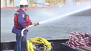 A man using a firehose