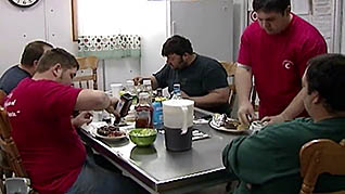 Men eating around a table