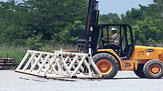 Forklift moving metal on construction site
