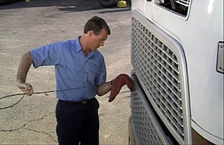 Checking the oil of your heavy truck before driving through adverse conditions