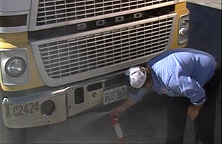 A man spraying his truck