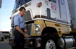 Man inspecting exterior of truck