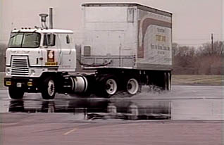 A truck hauling rectangular cargo on a wet road how to judge distance and speed when driving a heavy truck.