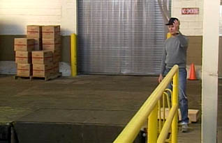 Man guiding truck into loading area