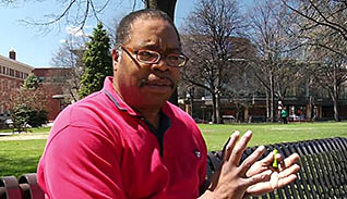 Man talking while sitting on a park bench