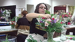 A woman watering flowers