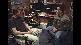 Two men talking in an office