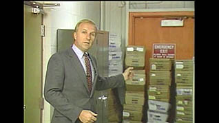 A man showing an example of boxes that are improperly stacked