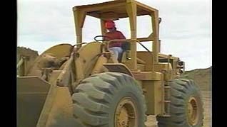 A man operating a wheel loader