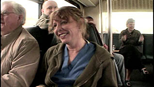 A women smiling while riding the bus
