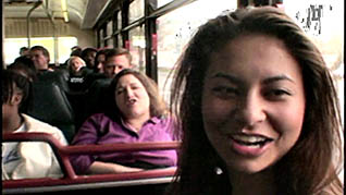 A women laughing while riding the bus