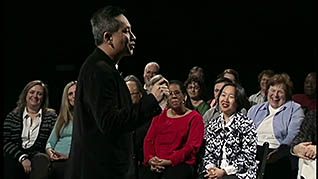 A man speaking in front of an audience