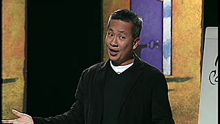 A man speaking at a seminar