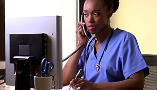 Woman in scrubs on the phone