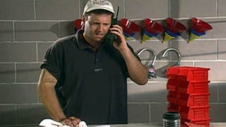 A worker speaks on the phone in the How to Deal with a Foreign Accent training video