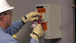 A man using the lockout/tagout procedure